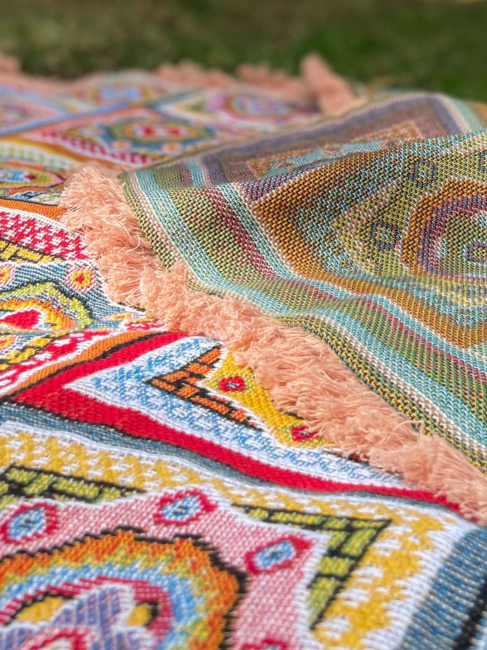 Forever Young Throw Blanket at a picnic showing it is double sided reversible. Vintage retro nanna crochet design
