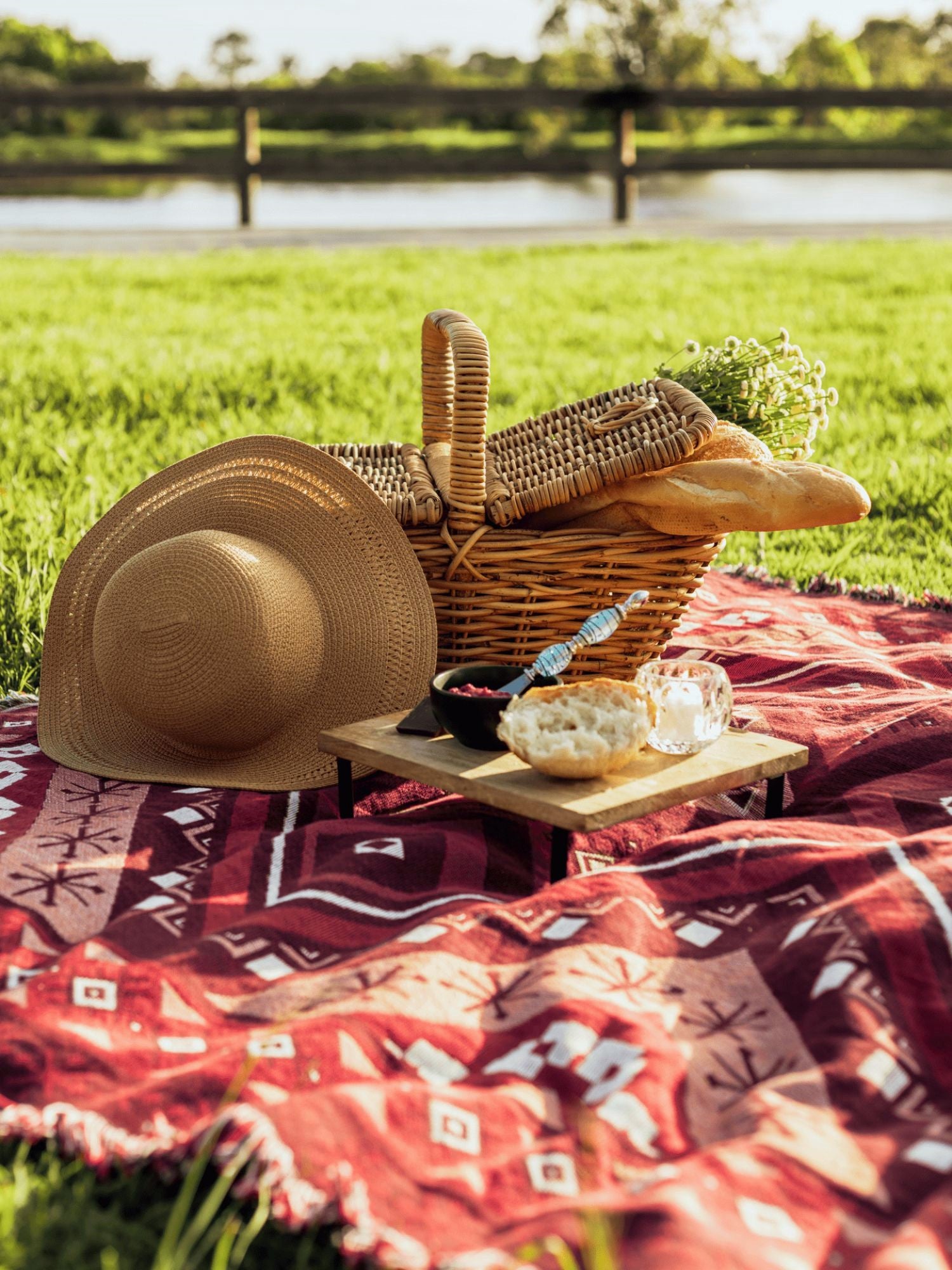 Picnic basket with red picnic blanket throw rug. Valentines picnic idea. Spring outdoors self-care