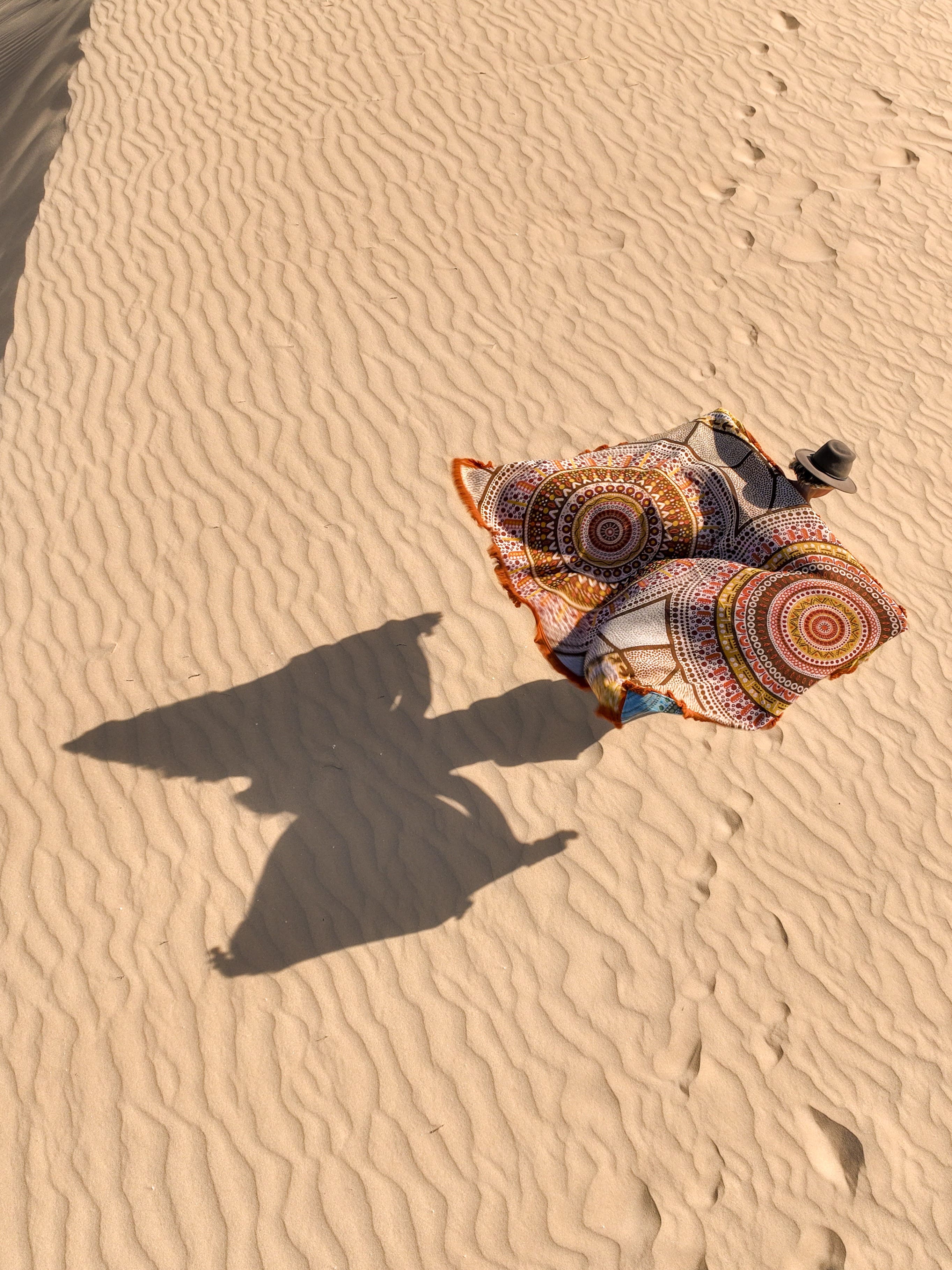 Stomping Ground throw rug design, Indigenous Aboriginal art beach blanket in orange and brown tones