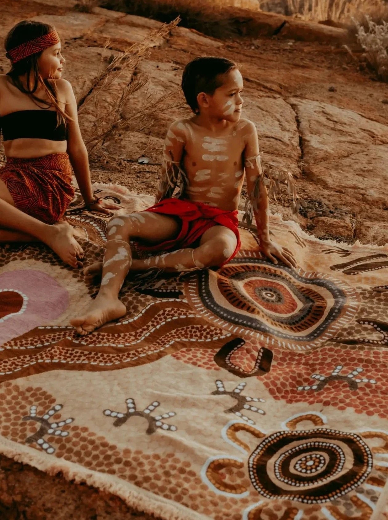 Coming Home Indigenous First Nations art throw rug on Kalkadoon land. Woven from recycled fabrics. First Nations art, Kalkadoon mob designed in Australia