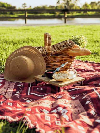 Picnic basket with red picnic blanket  throw rug. Valentines picnic idea. Spring outdoors self-care