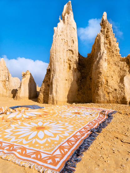 Yellow and orange throw rug perfect for self-care. XL size to fit over queen bed or family picnic. Designed in Australia - Better Days van life companion for big lap of oz. On sand at Pinnacles